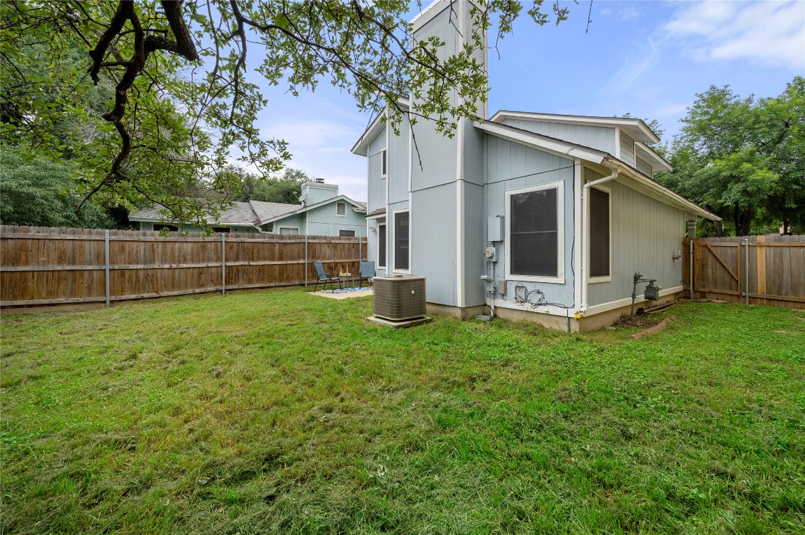 7705 Grovedale Trail Austin, TX 78729 - Photo 24 of 25 a view of a house with backyard and a tree