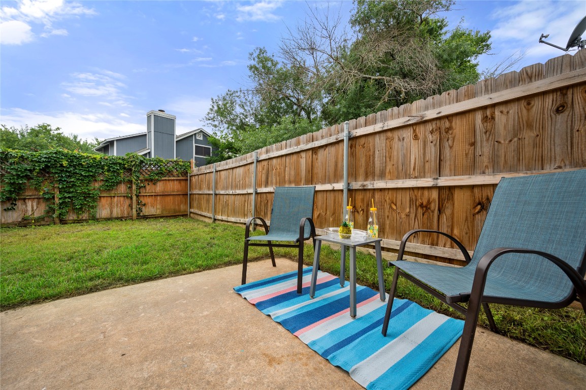7705 Grovedale Trail Austin, TX 78729 - Photo 25 of 25 a backyard of a house with wooden floor and outdoor seating