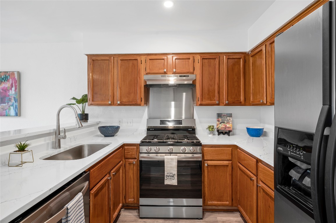 7705 Grovedale Trail Austin, TX 78729 - Photo 8 of 25 a kitchen with sink a stove and cabinets