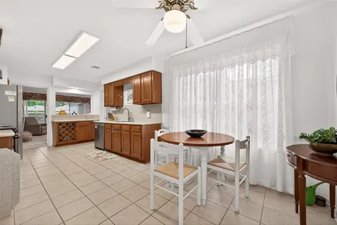 a kitchen with a sink window and cabinets