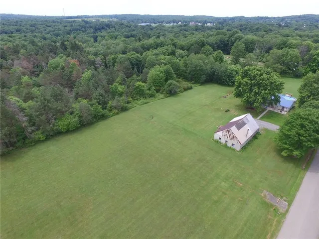 a aerial view of a house with a yard