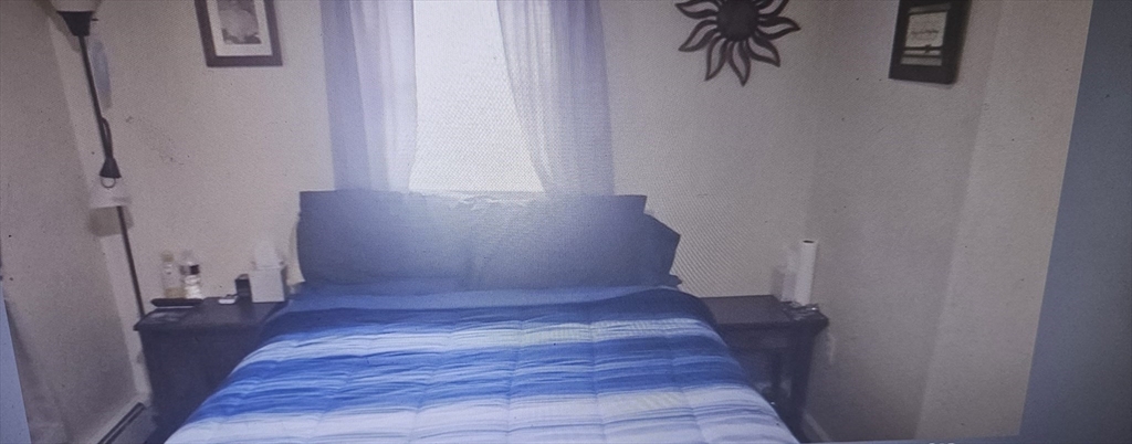 39 Union Street, Unit 1ST REAR Taunton, MA 02780 - Photo 5 of 5 a view of a hallway with wooden floor and staircase