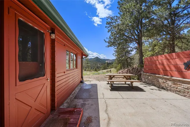a view of a backyard of house with outdoor seating