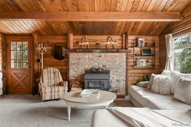 a living room with furniture a fireplace and a table