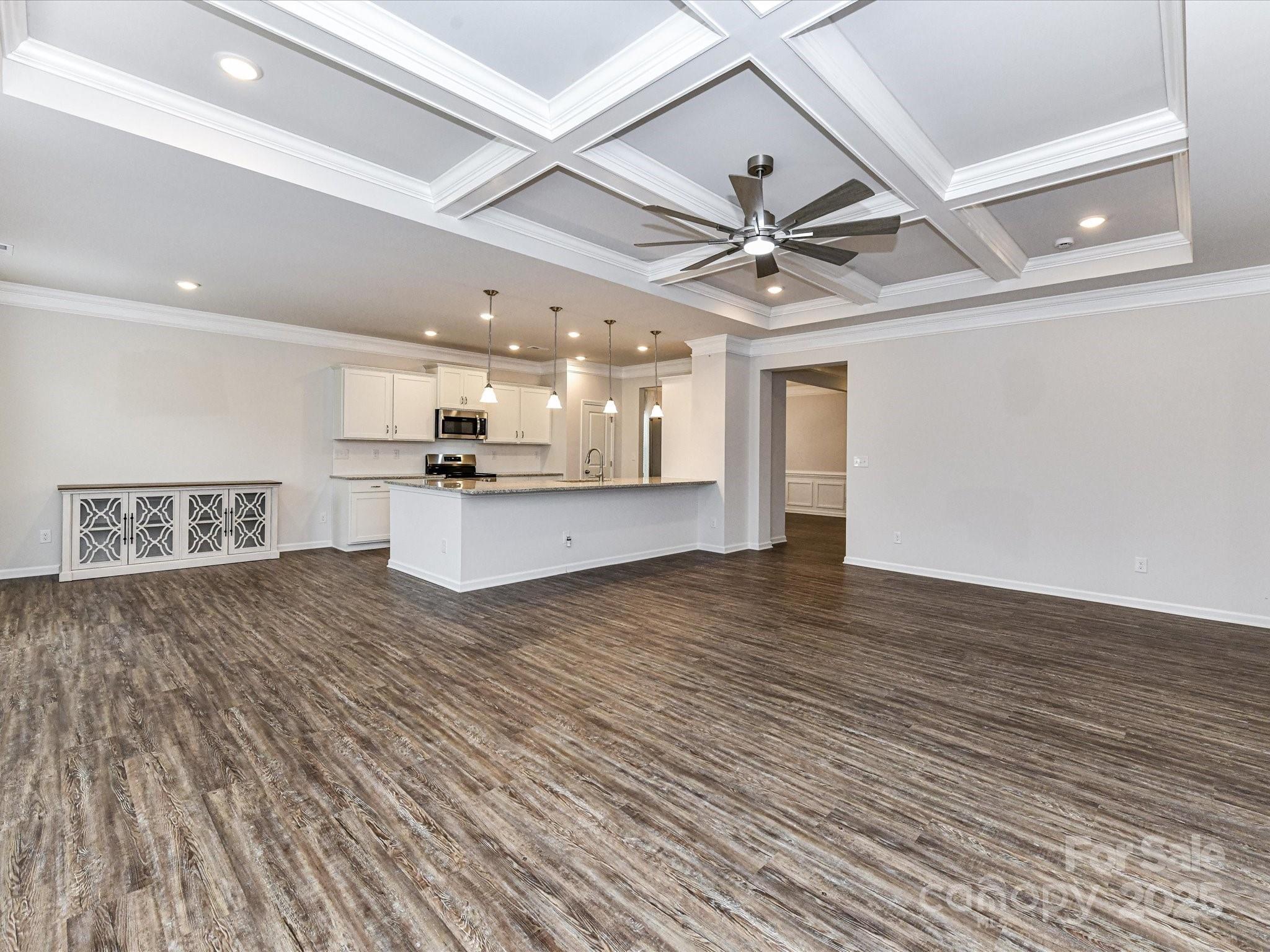 6168 Busch Way Midland, NC 28107 - Photo 16 of 42 a view of a kitchen with a stove and a chandelier