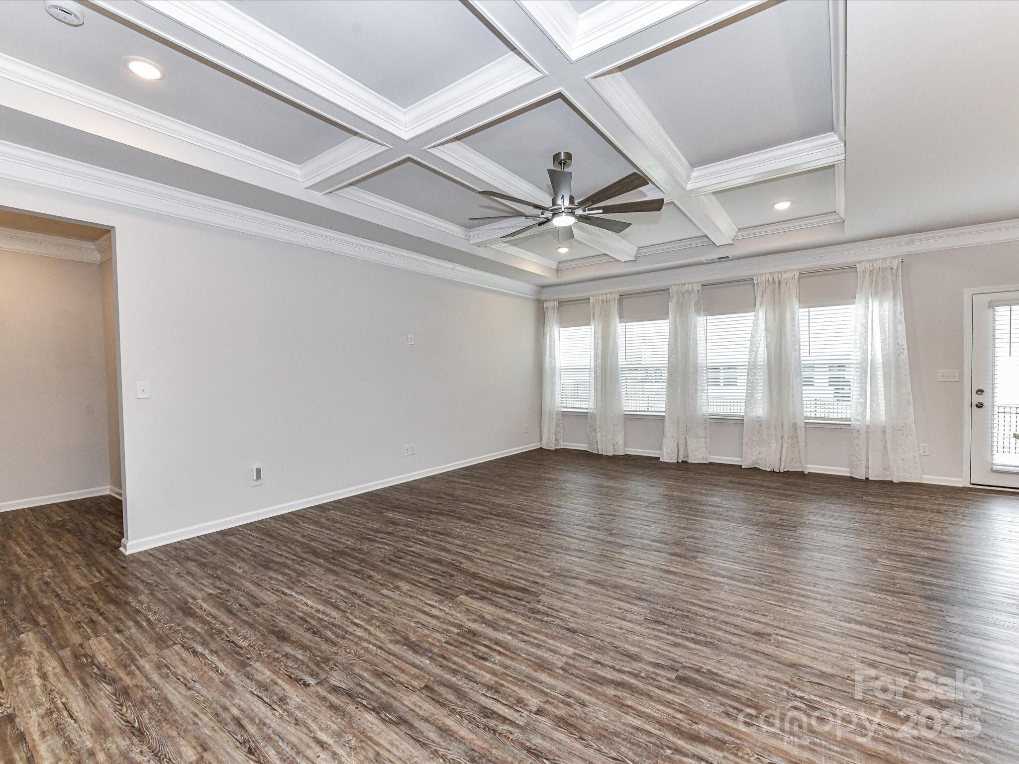 6168 Busch Way Midland, NC 28107 - Photo 18 of 42 a view of an empty room with wooden floor and a window