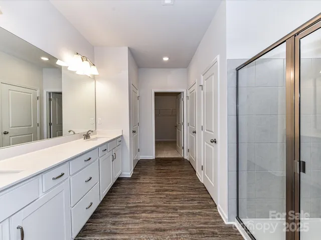 a bathroom with a double vanity sink and a mirror