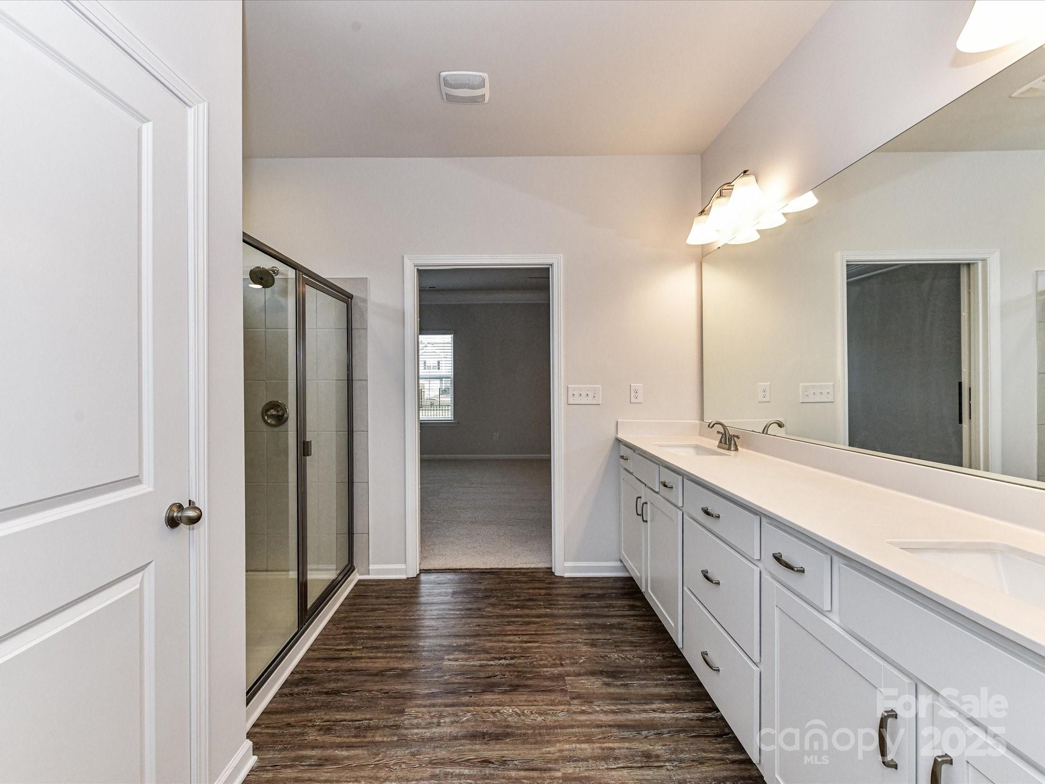 6168 Busch Way Midland, NC 28107 - Photo 24 of 42 a bathroom with a double vanity sink and a mirror