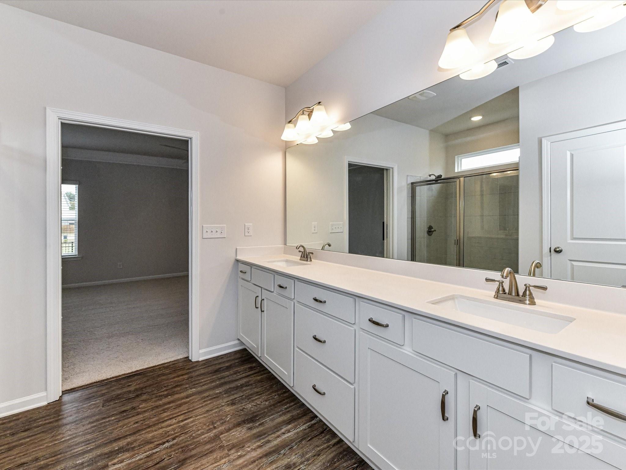 6168 Busch Way Midland, NC 28107 - Photo 25 of 42 a bathroom with a double vanity sink and a mirror