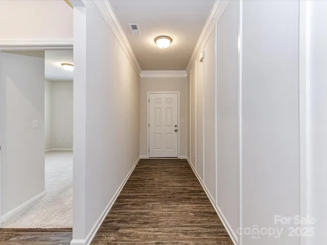 a view of a room with wooden floors and ceiling fan