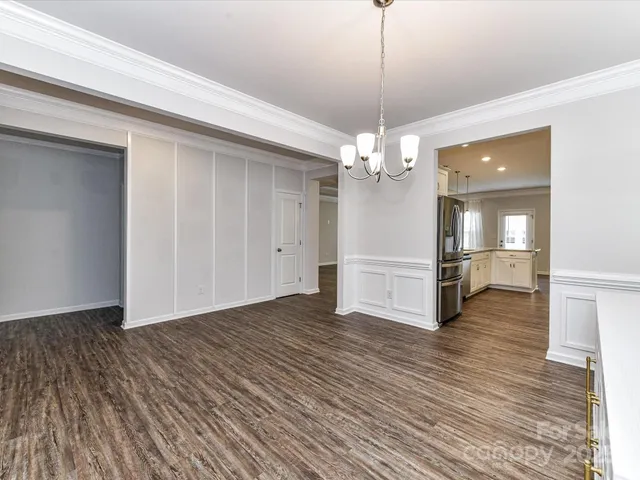 a view of a kitchen with a sink and wooden floor