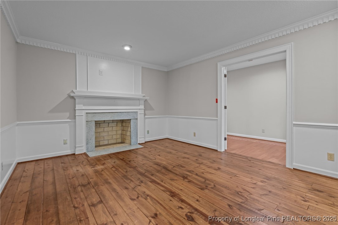 610 Maynard Lake Road Erwin, NC 28339 - Photo 10 of 49 a view of empty room with wooden floor and fireplace