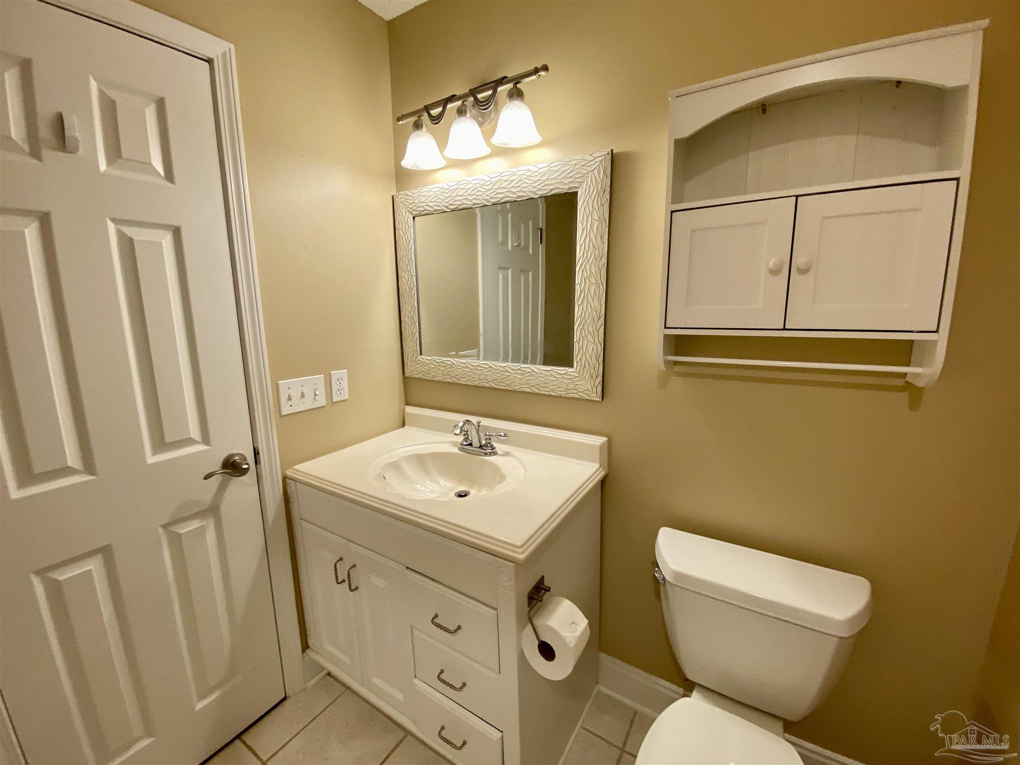 9022 Governors Pl Court Pensacola, FL 32514 - Photo 11 of 16 a bathroom with a toilet sink and mirror