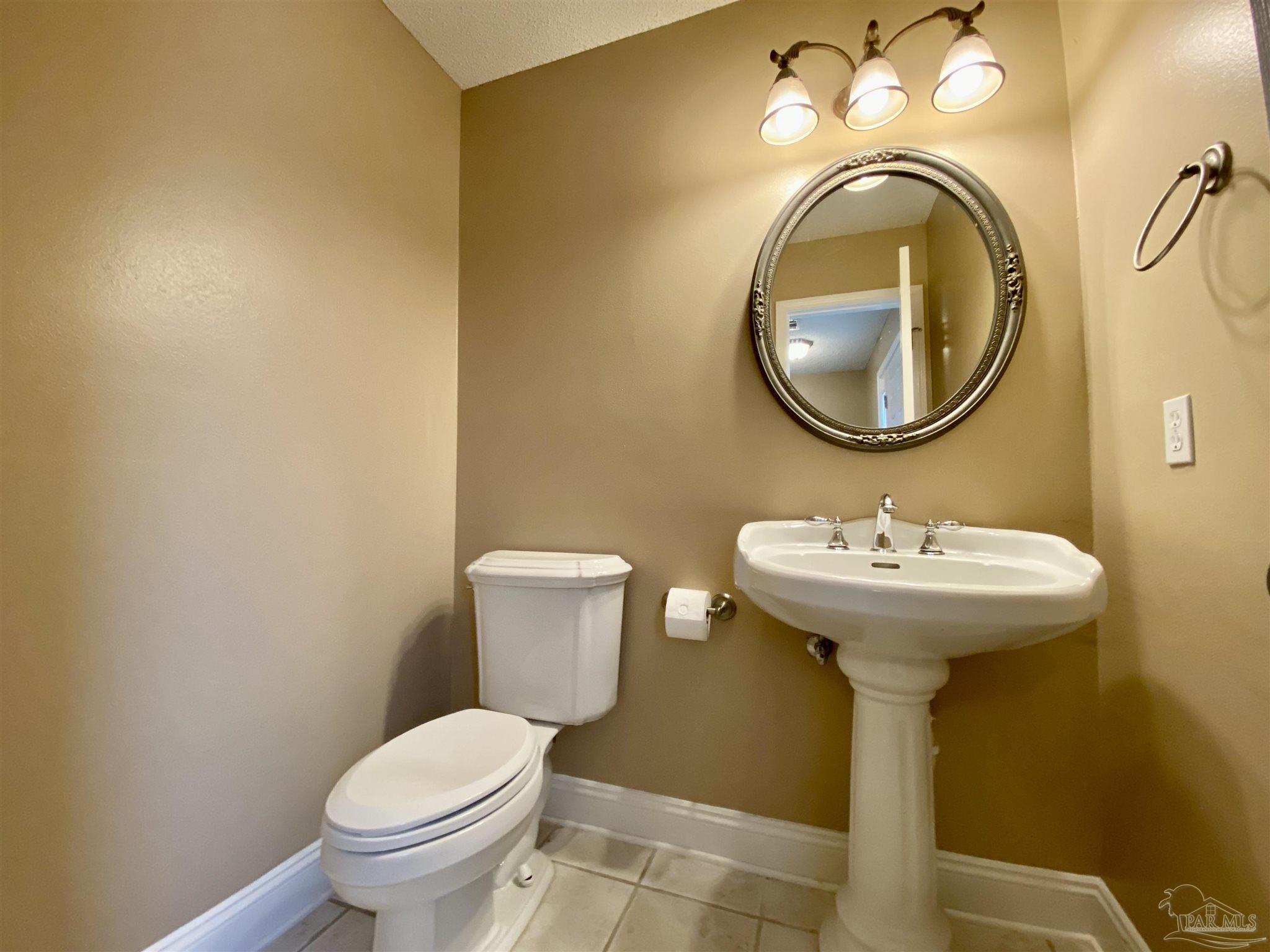 9022 Governors Pl Court Pensacola, FL 32514 - Photo 13 of 16 a bathroom with a toilet sink and mirror