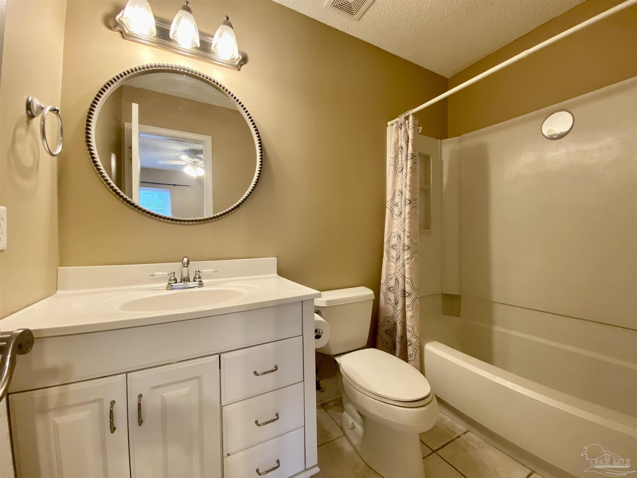 9022 Governors Pl Court Pensacola, FL 32514 - Photo 14 of 16 a bathroom with a sink a toilet and a mirror