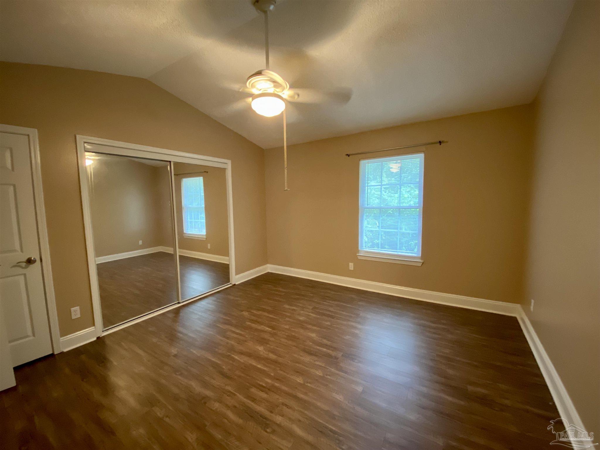 9022 Governors Pl Court Pensacola, FL 32514 - Photo 15 of 16 a view of an empty room with wooden floor and a window