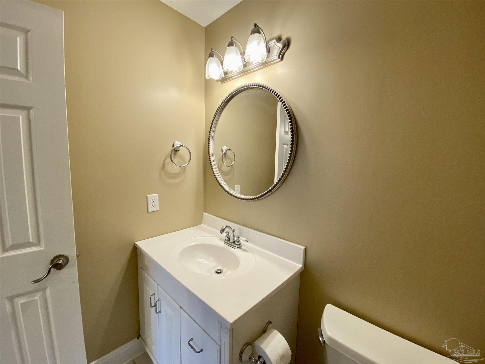9022 Governors Pl Court Pensacola, FL 32514 - Photo 16 of 16 a bathroom with a sink and a mirror