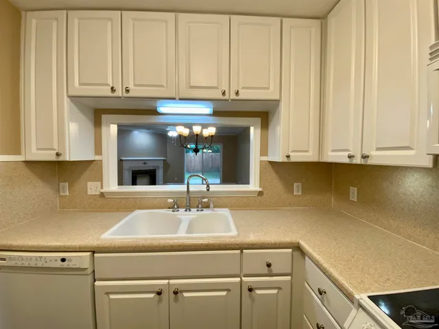 a kitchen with stainless steel appliances granite countertop a sink a refrigerator and cabinets