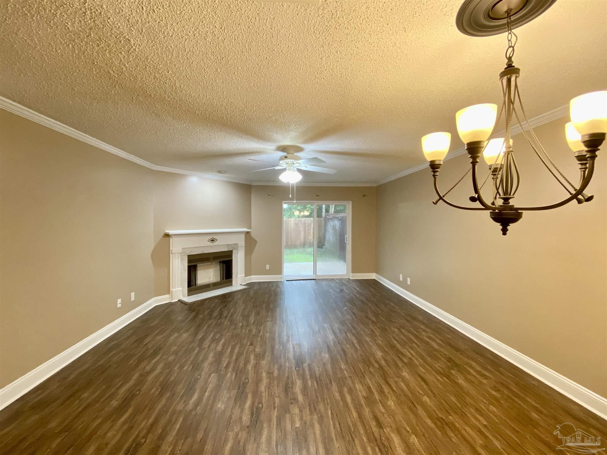 9022 Governors Pl Court Pensacola, FL 32514 - Photo 5 of 16 a view of empty room with wooden floor and fan