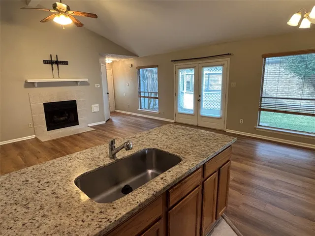 a kitchen with granite countertop a sink and a stove