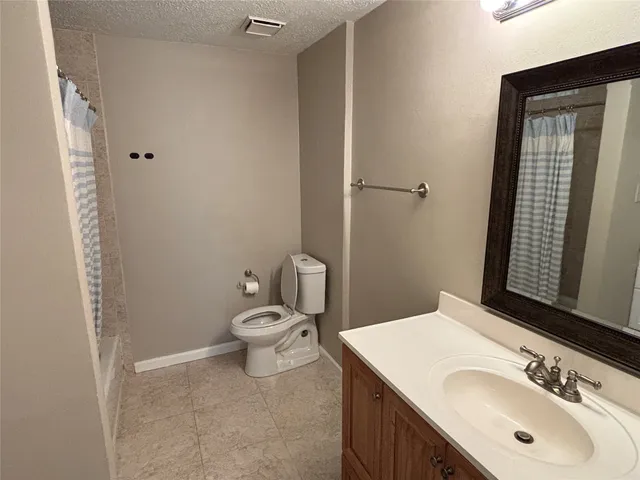 a bathroom with a sink toilet and vanity