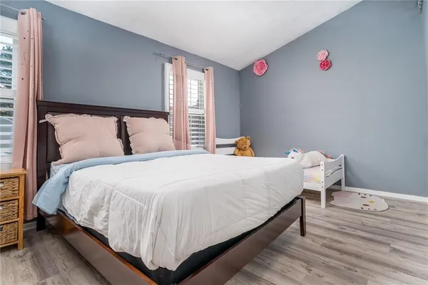 a large bed sitting in a bedroom next to a window