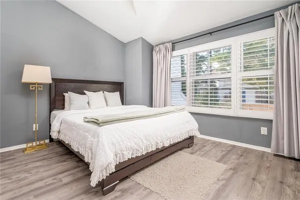 a bedroom with a large bed and a large window