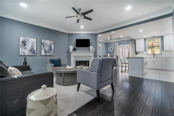 a living room with furniture a flat screen tv and a fireplace