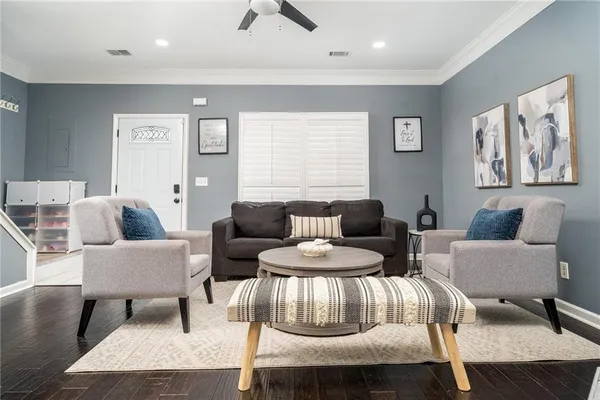 a living room with furniture and wooden floor