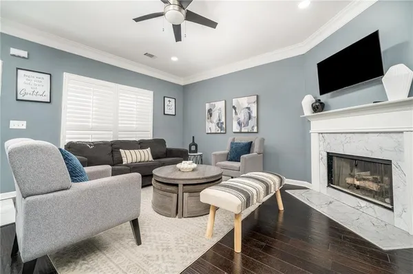 a living room with furniture a flat screen tv and a fireplace
