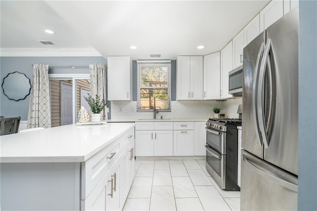 3539 Mt Vernon Circle Atlanta, GA 30340 - Photo 7 of 15 a kitchen with granite countertop a refrigerator stove top oven and sink