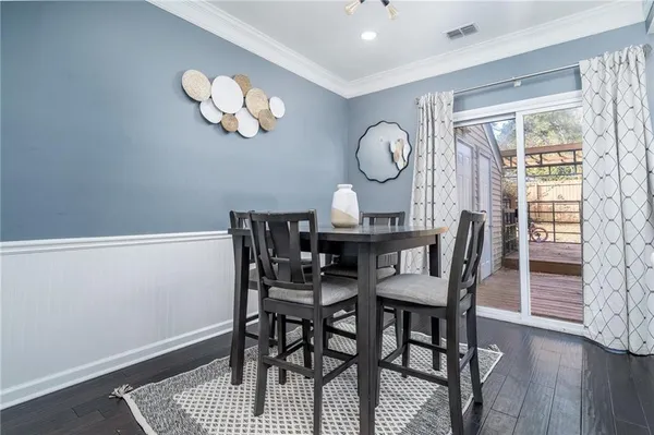 a view of a dining room with furniture and wooden floor