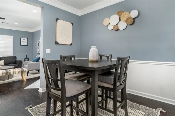 a view of a dining room with a table and chairs