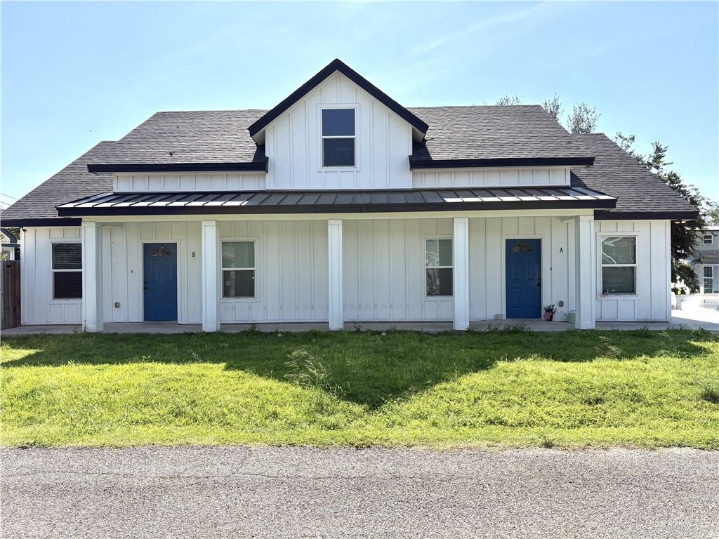 10308 Ramon Avenue Mission, TX 78573 - Photo 1 of 1 Modern farmhouse style home with a shingled roof, a standing seam roof, and board and batten siding