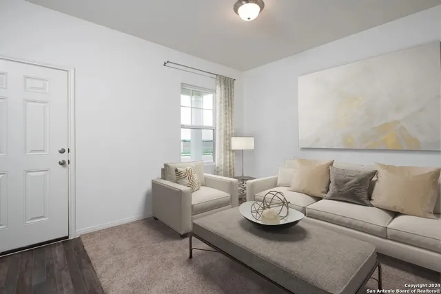 a living room with furniture and a table