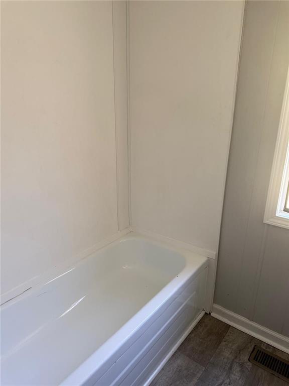 2457 Bold Springs Road Monroe, GA 30656 - Photo 18 of 23 a bathroom with bathtub and window