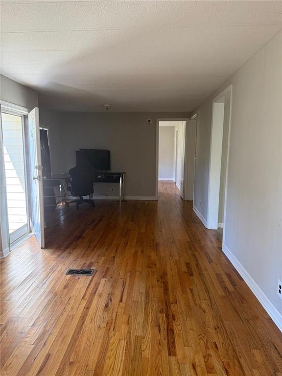 2457 Bold Springs Road Monroe, GA 30656 - Photo 6 of 23 a view of empty room with wooden floor and furniture