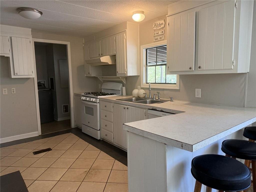 2457 Bold Springs Road Monroe, GA 30656 - Photo 8 of 23 a kitchen a sink a refrigerator and cabinets