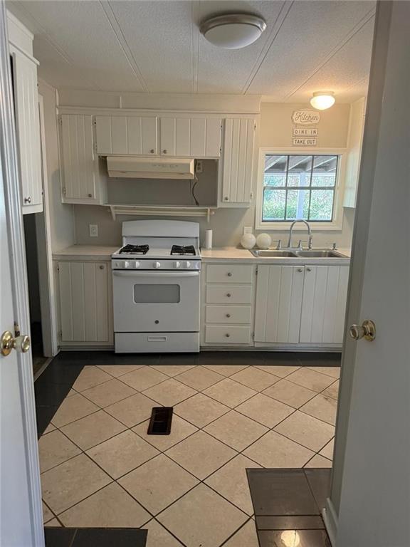 2457 Bold Springs Road Monroe, GA 30656 - Photo 9 of 23 a kitchen with white cabinets and a stove top oven