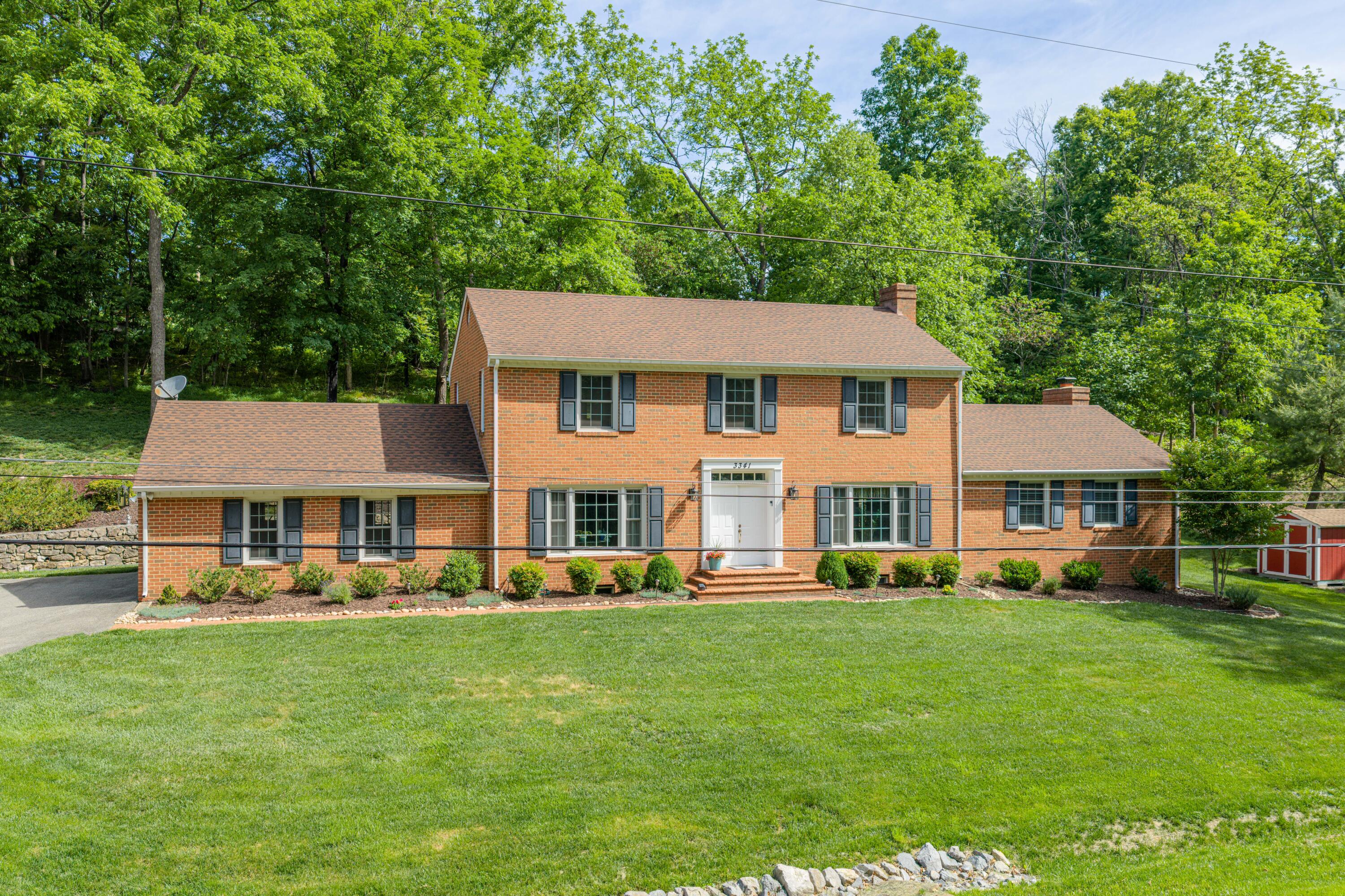 3341 Hidden Oak Road Southwest Roanoke, VA 24018 - Photo 2 of 26 a front view of a house with a garden and trees