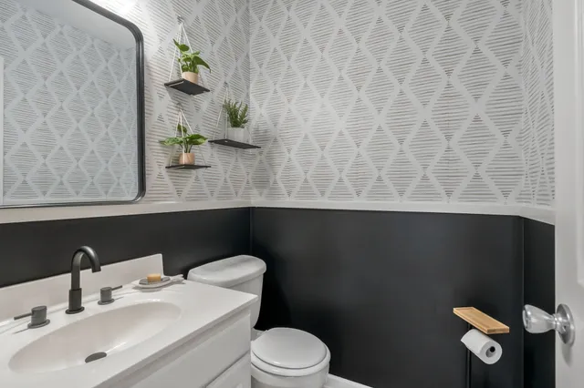 a bathroom with a sink a toilet and vanity