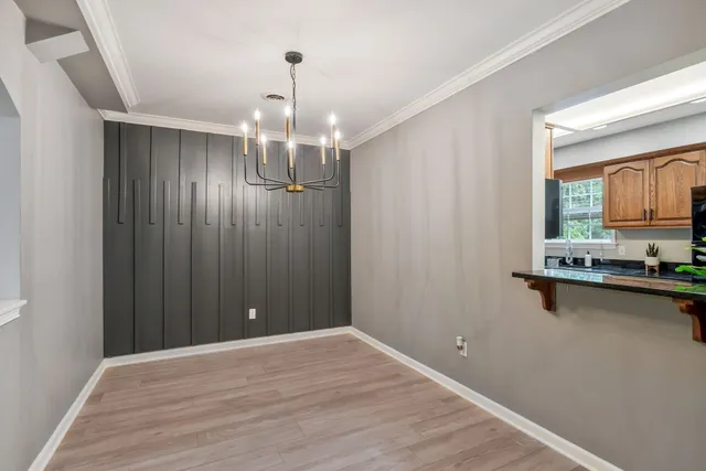 a view of a kitchen with wooden floor and a window
