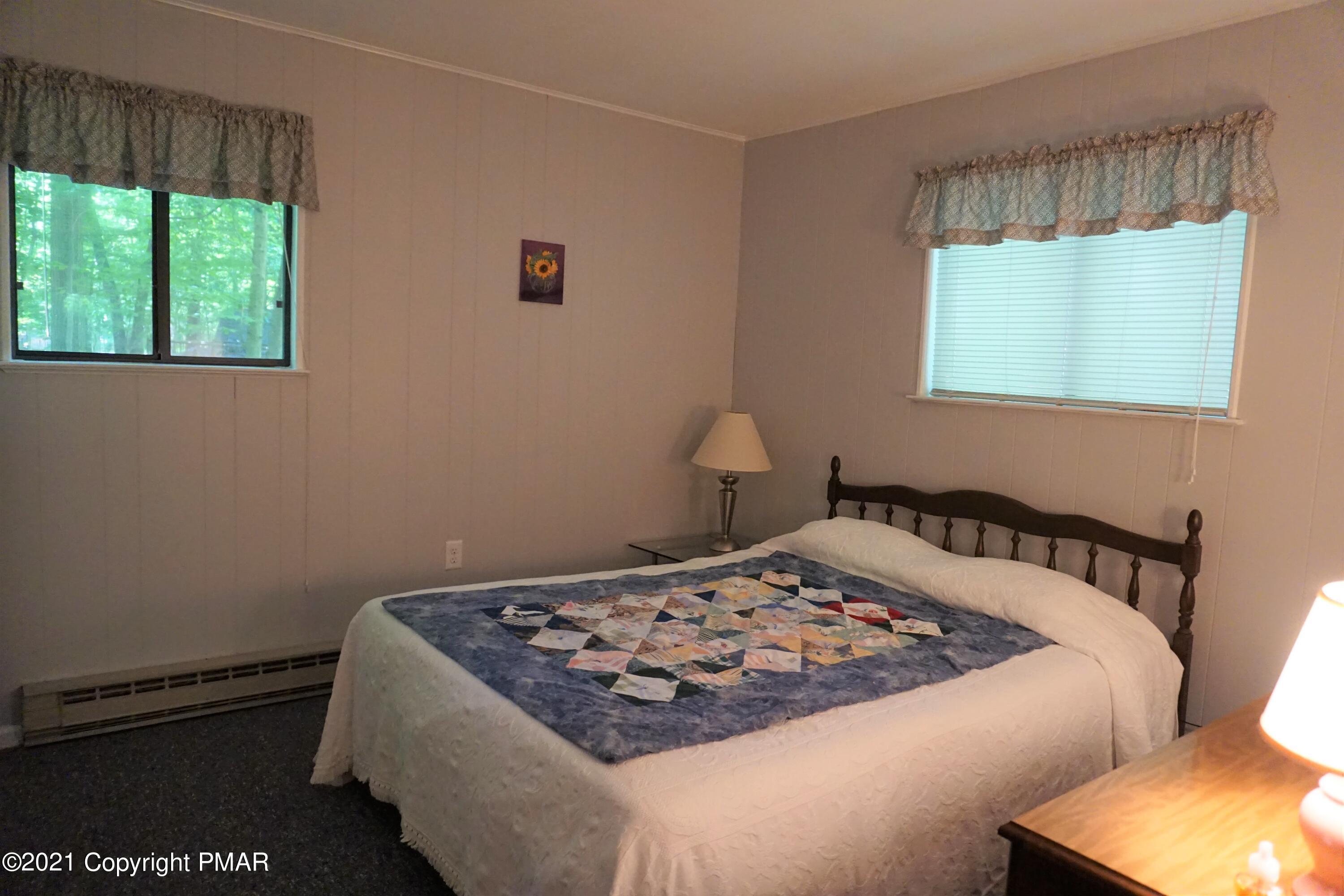 1069 Maple Drive Pocono Lake, PA 18347 - Photo 14 of 22 a bedroom with a bed and a window