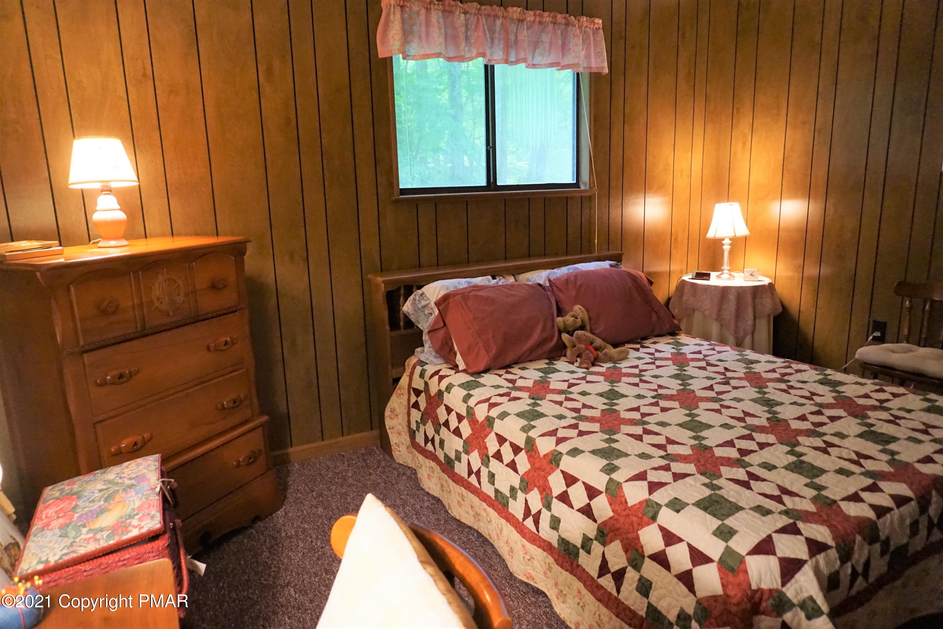 1069 Maple Drive Pocono Lake, PA 18347 - Photo 19 of 22 a bedroom with a bed and window