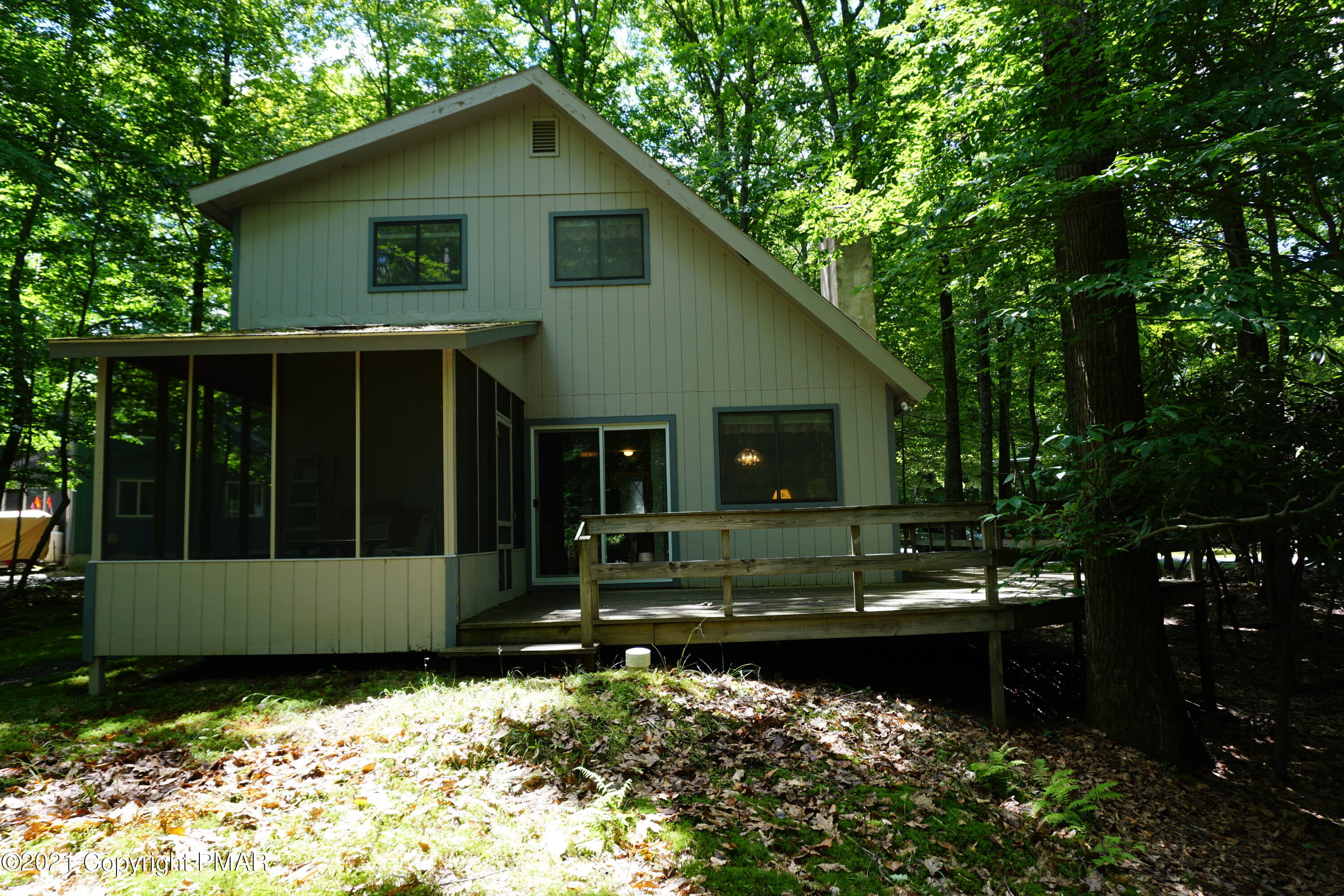 1069 Maple Drive Pocono Lake, PA 18347 - Photo 3 of 22 a front view of a house with a garden