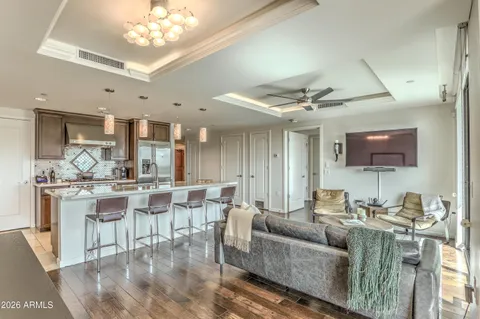 a kitchen with a sink and chairs