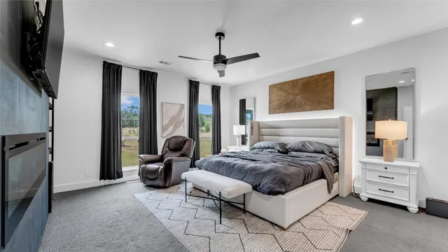 a bedroom with a bed and glass walk in closet