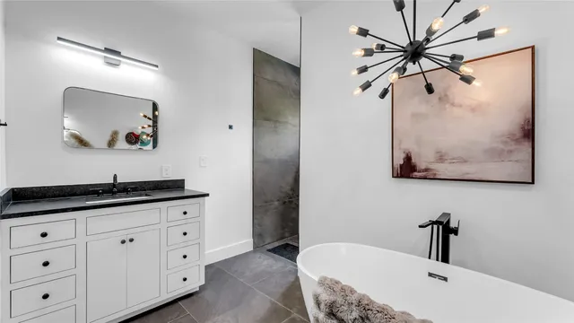 a bathroom with a granite countertop sink a mirror and vanity