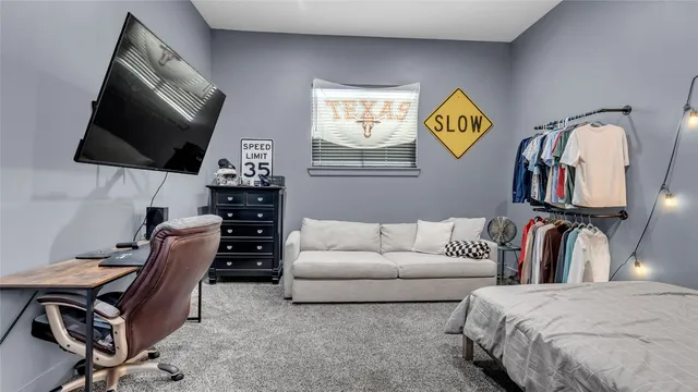 a bedroom with a bed and a large window