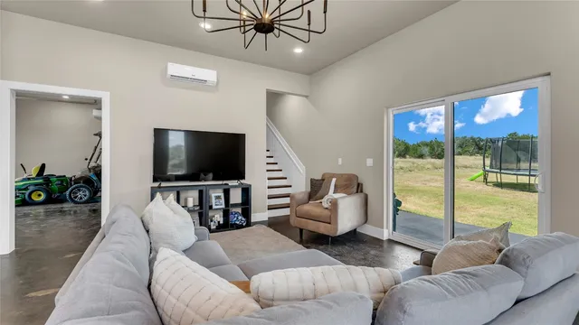 an empty room with windows and ceiling fan